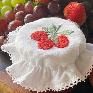 Raspberry glass lid embroidered with lace