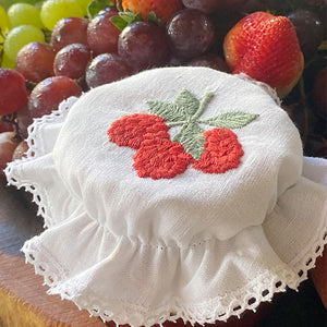 Raspberry glass lid embroidered with lace